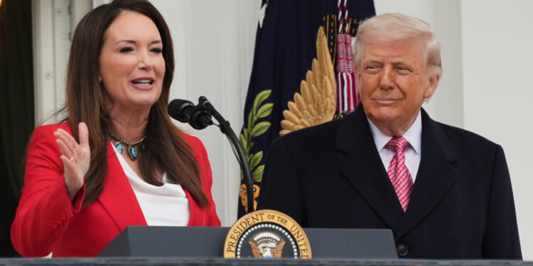 President Donald Trump listens to Agriculture Secretary Brooke Rollins speak during an event with farmers on the South Lawn of the White House on Friday, March 27, 2026, in Washington, D.C.