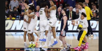 The Michigan Wolverines celebrate after defeating the UConn Huskies 69-63 in the National Championship of the 2026 NCAA Men's Basketball Tournament Monday in Indianapolis, Indiana.