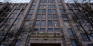 The Washington Post Headquarters stands flanked by bare black trees on January 27, 2026.