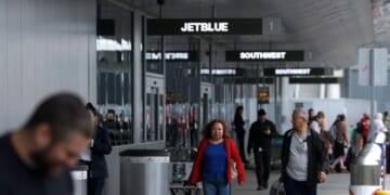 Travelers walk with their bags at Los Angeles International Airport on March 31, 2026, in Los Angeles, California.