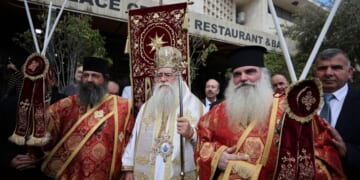 Christians in Bethlehem receive the Holy Fire at the Church of the Nativity after it arrived from the Church of the Holy Sepulchre in Jerusalem, on Holy Saturday according to the Eastern Orthodox calendar, on April 11, 2026.