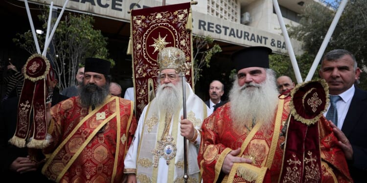 Christians in Bethlehem receive the Holy Fire at the Church of the Nativity after it arrived from the Church of the Holy Sepulchre in Jerusalem, on Holy Saturday according to the Eastern Orthodox calendar, on April 11, 2026.