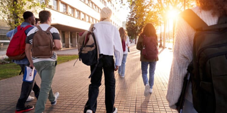 Students walk on a college campus.