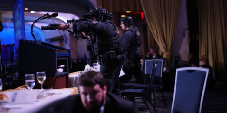 Agents stand guard after a shooting took place at the White House Correspondents' dinner at the Washington Hilton in Washington, DC on April 25, 2026.