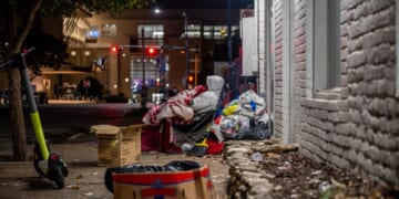 A southern street is strewn with trash.